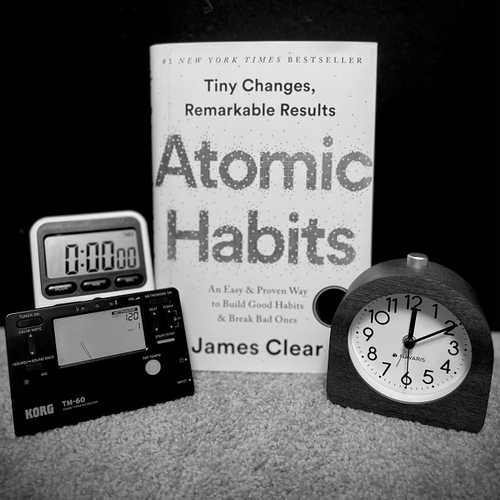 I've been distancing myself from social media for a short while to allow for some time and space to reflect, reexamine, and refocus. The top of the year is always a great time to do so, but rather than setting resolutions, developing systems underneath is far more important and effective. I've been changing a lot about myself in my day-to-day and owe a lot of the recent positive growth to this book, Atomic Habits, by @jamesclear 
•
Pictured along with the book is a metronome, timer, and alarm clock. All three of which a phone has the capability of doing - and that's exactly the point. I've found that my phone proves to be far too great of a distraction from my practice. It serves as a visual cue; when I go to change the tempo or timer on the respective app, I'm hit with notifications, tempted to check social media, the news, etc. and my mind starts racing about things that have nothing to do with what's right in front of me. In the book, Clear identifies one of the laws of creating a new habit is to make it easy, but to stop a bad habit, you invert it by making it difficult. I now place my phone outside of my studio so I can't see or hear it and use the metronome and timer instead. In the mornings, I use my alarm clock instead of my phone so I'm not tempted to check my phone for email, notifications, etc. right when my eyes are opening. By making it difficult to access my phone at strategic times, I increase the efficacy of being in the moment. 
•
This is the book you didn't know you needed. It's fascinating how just about everything we do is attributed to habits. You have the power to start a new habit or stop a current bad habit, and it's much simpler than you think. 
•
•
•
•
•
#drumeo #drumfam #drummersofinstagram #drumpractice #drumsdaily #drumsdrumsdrums #drumsession #drumsetup #drumsharing #drumshed #drumslife #drumsoutlet #drumstagram #drumstep #drumstudio #drumsview #drumuniversity #drumvideos #instadrum #instadrummers #instadrums #instagroove_ #LAdrummer #LAmusic #LAmusicscene #practiceeveryday #sjcdrums #teamremo #selfhelp #personaldevelopment